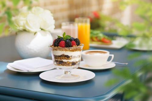 a table with a dessert and a cup of coffee at COMO Metropolitan London in London