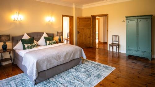 a bedroom with a bed and a blue cabinet at Gut Alt Necheln in Brüel