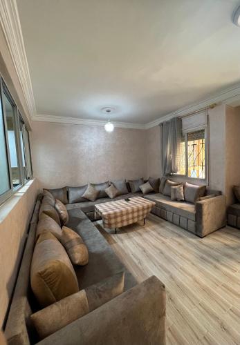 a large living room with a couch and a table at beach apartment in Fnidek
