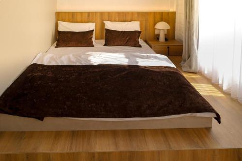 a bedroom with a large bed with a brown blanket at RA Boutique Hotel in Baku