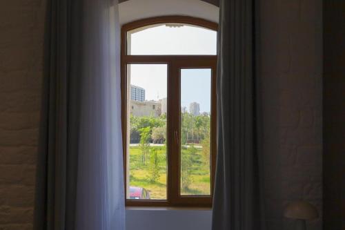 an open window with a view of a city at RA Boutique Hotel in Baku