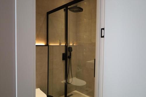 a shower with a glass door in a bathroom at RA Boutique Hotel in Baku