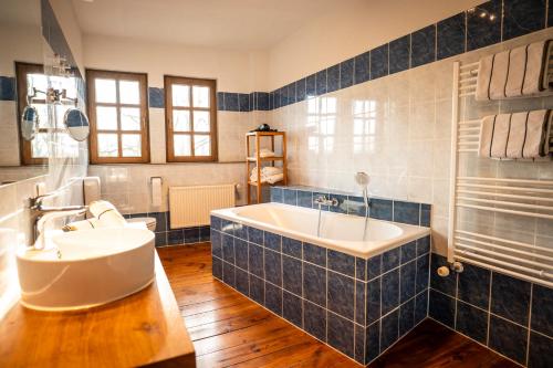 a bathroom with a large tub and a sink at Gut Alt Necheln in Brüel