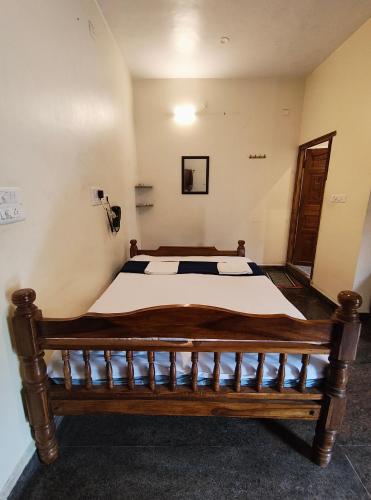 a bedroom with a large bed in a room at Art Le Cafe in Auroville
