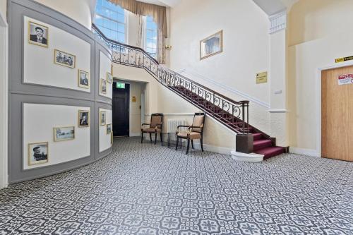 a hallway with stairs and a table and chairs at Stylish Dudley Studio with Kitchen and Parking in Dudley