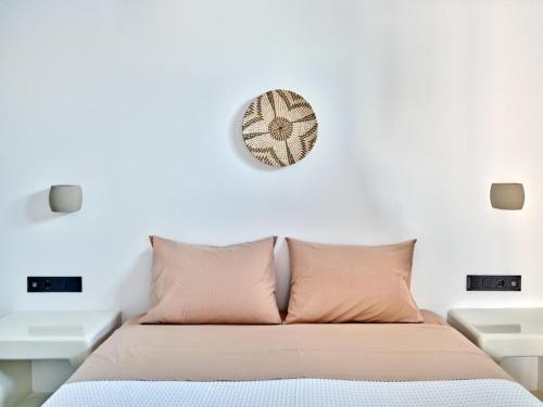 a bedroom with a bed and a clock on the wall at Ocean View Paros in Parikia