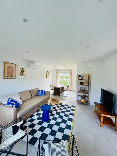 a living room with a couch and a table at La maison de Lili in Mercin-et-Vaux