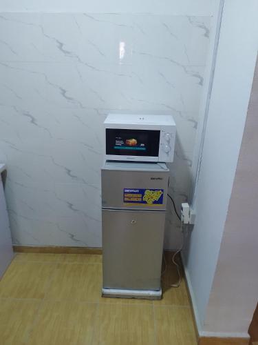 a microwave sitting on top of a cpu in a room at Peace Home in Lekki