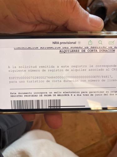 a person holding a cell phone with a piece of paper at Font Fresca House ETV 84817 in Deia