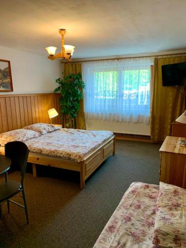 a hotel room with two beds and a window at Kwatery Prywatne U Bachledów in Zakopane