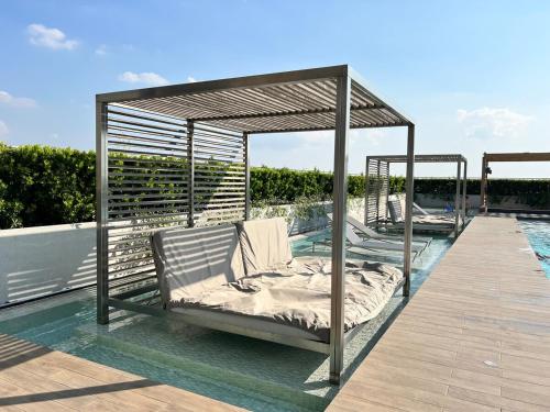 a canopy bed on a deck next to a swimming pool at Great facilities n River view n Local in Ban Sai Ma