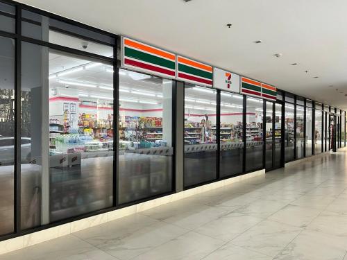 a store front with glass windows in a shopping mall at Great facilities n River view n Local in Ban Sai Ma