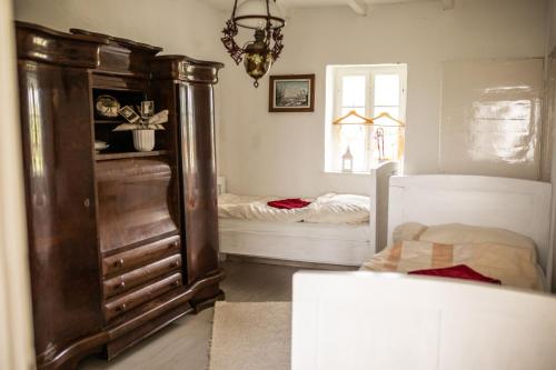 a bedroom with a large wooden cabinet and a bed at Pista bácsi háza in Pusztaföldvár