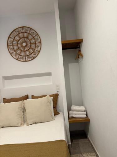 a bedroom with a bed and a clock on the wall at Estudio 1 Café Bernal in Tarifa