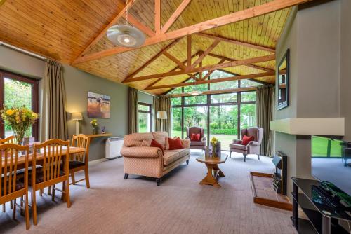 a large living room with a wooden ceiling at Castlerosse Park Resort Holiday Homes in Killarney