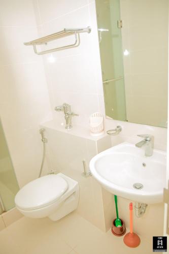 a bathroom with a toilet and a sink at Luxury fairway living-Galle apartments in Galle