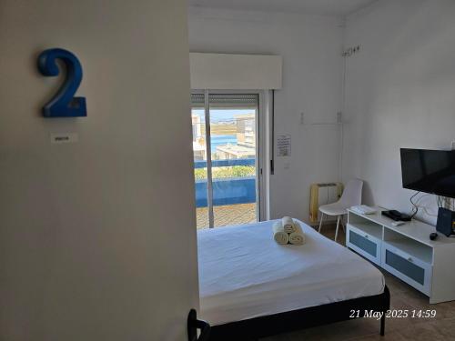 Ένα ή περισσότερα κρεβάτια σε δωμάτιο στο Blife Ceriya private rooms at Faro beach