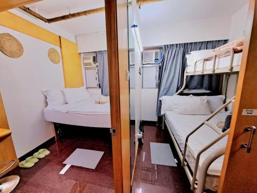 a small room with two bunk beds in it at Cozy full Apartment 2 bedroom central area in Hong Kong