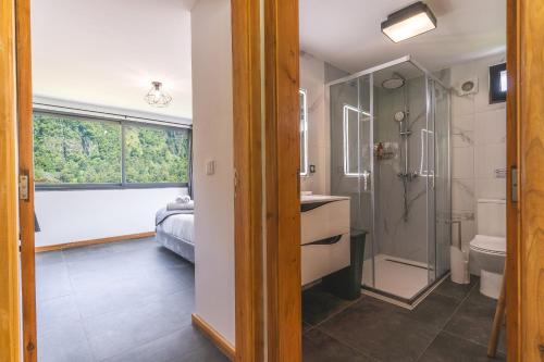 a bathroom with a shower and a sink and a toilet at Mystic Mountain by Atlantic Holiday in São Vicente