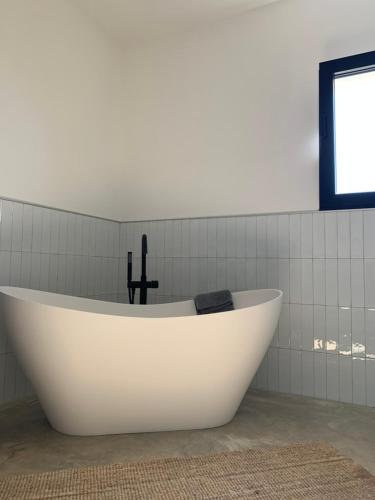 a white bath tub in a bathroom with a window at Villa Al Fianco in Petacciato