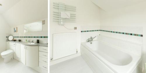 a white bathroom with a tub and a sink at 5 The Sanctuary, Thorpeness - Aldeburgh Coastal Cottages in Thorpeness
