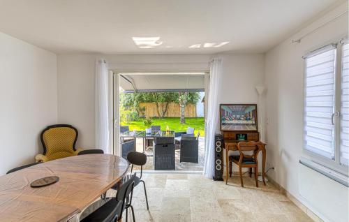 d'une salle à manger avec une table et une vue sur la cour. dans l'établissement Cozy Home In Dolus-Doléron With Wifi, à Dolus-d'Oléron