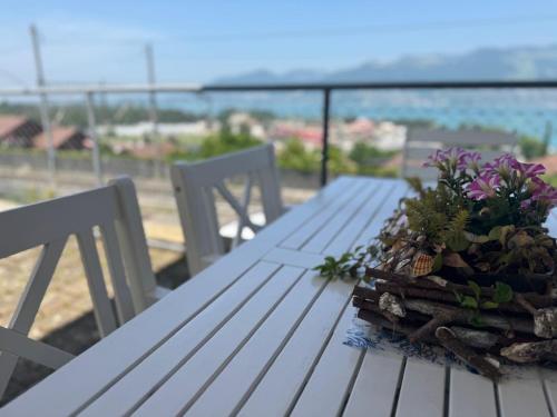 a white picnic table with a potted plant on it at Swiss Apartment Thunersee in Einigen