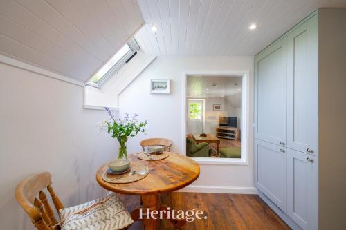 a dining room with a table and a window at The Byre, Countryside Home in Tough