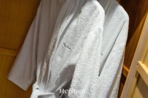 a white shirt is hanging on a closet at The Byre, Countryside Home in Tough