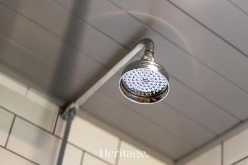 a shower head hanging from the ceiling of a bathroom at The Byre, Countryside Home in Tough