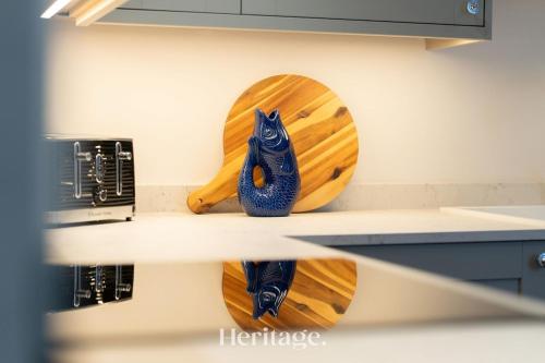 a blue cat figurine on a counter in a kitchen at The Byre, Countryside Home in Tough