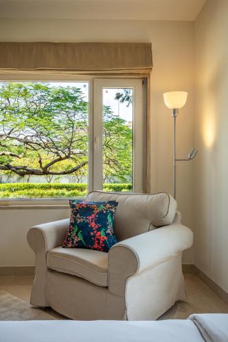 a living room with a couch and a window at Helen's Garden , Bhopal in Bhopal
