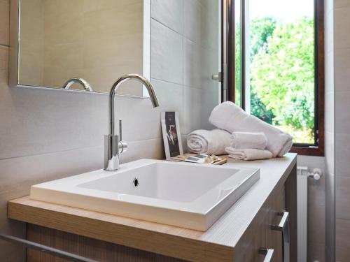 a bathroom with a white sink and a mirror at Appartamento Casa Francesca in Mergozzo