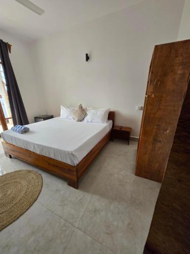 a bedroom with a large bed with white sheets at Smile Boutique Beach hotel in Nungwi