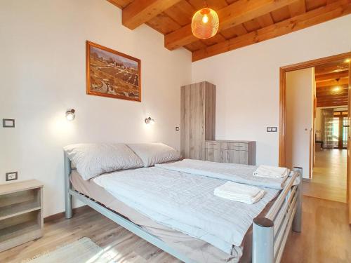 a bedroom with a bed in a room at Holiday house Woody with private pool - Biró Tours nr 88 in Vonyarcvashegy