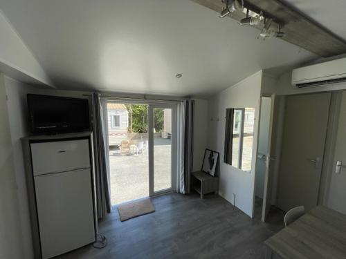 a living room with a television and a sliding glass door at Hotel Fritza in Olofström