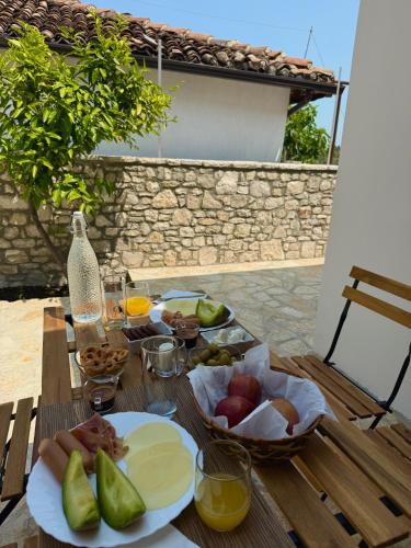 a wooden table with plates of food on it at Villa Merkaj, Berat Castle in Berat