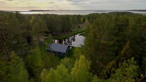 an aerial view of a house next to a lake at Jõeranna Pond House in Jõeranna