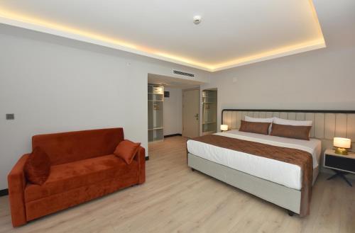 a bedroom with a large bed and a couch at Petra Hotel Trabzon in Trabzon