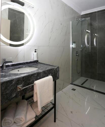 a bathroom with a sink and a shower at Petra Hotel Trabzon in Trabzon