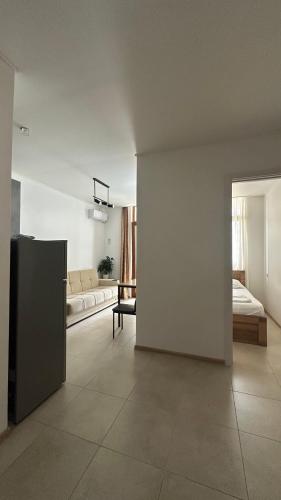 a room with a living room with a couch and a room with a couch at Aqua Batumi 47 in Batumi