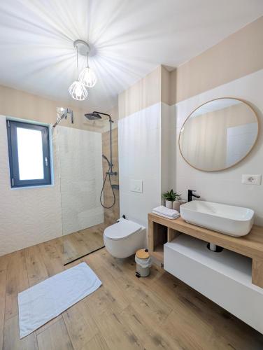 a bathroom with a toilet and a sink and a mirror at Yellow House in Comarnic