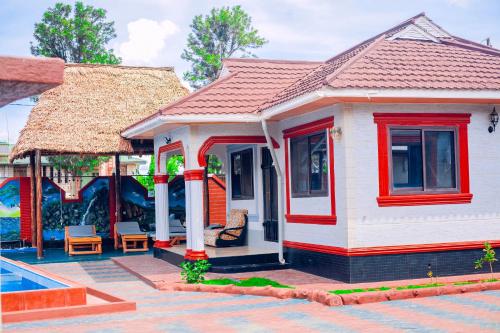 a small house with a pool in front of it at Eagle Cottages - Moshi in Moshi