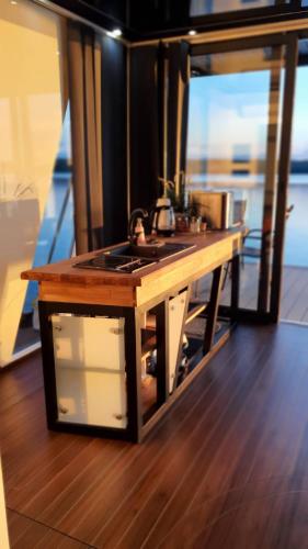 a kitchen with a stove top on a boat at Domy na wodzie Charzykowy in Charzykowy