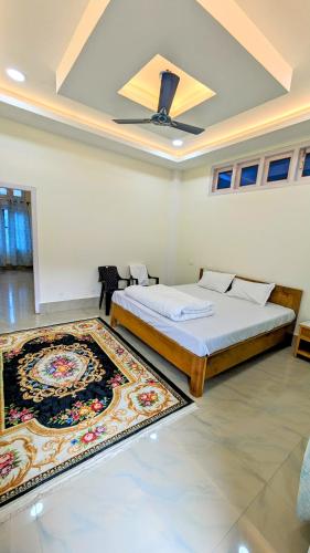 a bedroom with a large bed and a rug at Tara devi homestay in Dirang Dzong