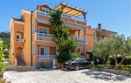 a house with a car parked in front of it at Lovely Apartment In Barbat Na Rabu in Barbat na Rabu