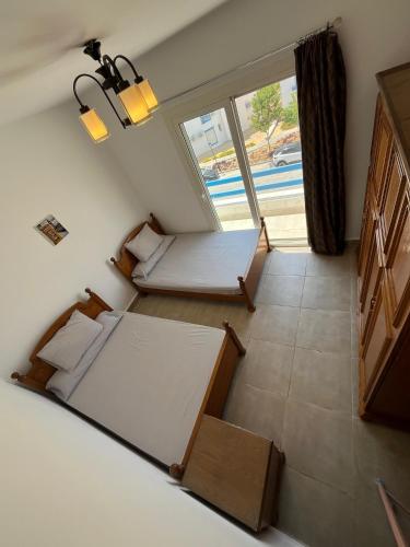 a room with two beds and a large window at Amazing 3 Bedrooms Penthouse MountainView Northcoast - Ras Elhekma in Ras Elhekma