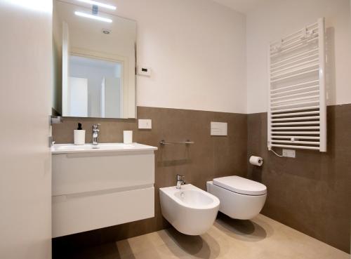 a bathroom with a toilet and a sink and a mirror at Brezza 4 in Gabicce Mare