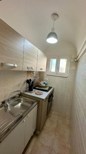 a small kitchen with a sink and a counter at Dimora Life in Locorotondo