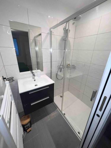 a bathroom with a shower and a sink and a glass shower stall at F2 Independent new city center Epône in Épône
